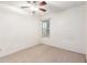 Neutral bedroom with carpeted floor, window, and ceiling fan at 7966 W Surrey Ave, Peoria, AZ 85381