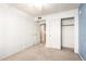 This bedroom features neutral carpet, a ceiling fan and closet space at 7966 W Surrey Ave, Peoria, AZ 85381