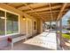 The covered patio has a seating area and leads to the pool and putting green at 7966 W Surrey Ave, Peoria, AZ 85381