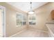 Cozy dining area bathed in natural light from large windows at 7966 W Surrey Ave, Peoria, AZ 85381