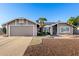Charming single-story home with desert landscaping, two-car garage, and solar panels at 7966 W Surrey Ave, Peoria, AZ 85381