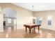 Open concept living room with hardwood flooring, a pool table and a cozy fireplace at 7966 W Surrey Ave, Peoria, AZ 85381