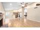 Open floor plan connecting the living room, kitchen, and pool table room with fireplace at 7966 W Surrey Ave, Peoria, AZ 85381
