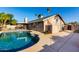 Enjoy this spacious backyard with a large pool, patio area, and desert landscaping at 7966 W Surrey Ave, Peoria, AZ 85381