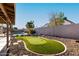 This backyard features an artificial turf putting green for entertainment and practice at 7966 W Surrey Ave, Peoria, AZ 85381
