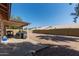 Spacious backyard with covered patio area, gravel landscaping, and block wall offering privacy at 821 E Chicago St, Chandler, AZ 85225