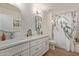 Bright bathroom featuring dual sinks and shower with a decorative curtain at 821 E Chicago St, Chandler, AZ 85225