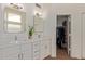 A bright bathroom with dual sinks, white cabinets and quartz countertops and a separate closet at 821 E Chicago St, Chandler, AZ 85225