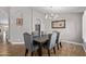 Elegant dining room with a chandelier, wood-look floors, and neutral wall paint at 821 E Chicago St, Chandler, AZ 85225