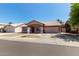 Charming single-story home featuring a tile roof, neutral tones, a two-car garage, and desert landscaping at 821 E Chicago St, Chandler, AZ 85225