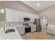 Beautiful kitchen with white cabinetry, quartz countertops, and stainless steel appliances at 821 E Chicago St, Chandler, AZ 85225