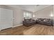 Inviting living room featuring wood-look floors, neutral paint, two sofas with pillows, and a front door at 821 E Chicago St, Chandler, AZ 85225