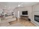 Open-concept living room with wood-look floors, fireplace, and seamless flow to other rooms at 821 E Chicago St, Chandler, AZ 85225