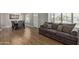 Open-concept living room featuring wood-look floors, a sofa, a dining table, and natural light at 821 E Chicago St, Chandler, AZ 85225