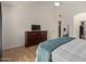A nicely decorated main bedroom featuring wood-look floors, walk-in closet, and an ensuite bathroom at 821 E Chicago St, Chandler, AZ 85225