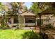 Backyard featuring lush trees, grass, lattice cover and view of the home at 930 E Page St, Gilbert, AZ 85234