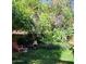 Lush backyard featuring mature trees, a cozy seating area, and charming garden accents at 930 E Page St, Gilbert, AZ 85234