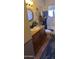 Bathroom vanity with granite countertop, decorative mirror, and tiled floor at 930 E Page St, Gilbert, AZ 85234