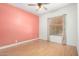 Bright bedroom featuring wood-look flooring, ceiling fan and a window with wood-look blinds at 930 E Page St, Gilbert, AZ 85234
