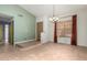 Open-concept dining room with tile flooring, a chandelier, and a large window for natural lighting at 930 E Page St, Gilbert, AZ 85234