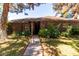 Charming single-story brick home featuring mature trees, a well-maintained lawn, and welcoming front entrance at 930 E Page St, Gilbert, AZ 85234