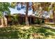 Inviting brick home with lush front yard landscaping, offering a warm and welcoming curb appeal at 930 E Page St, Gilbert, AZ 85234