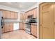 Well-lit kitchen featuring stainless steel appliances, granite countertops, and ample cabinet space at 930 E Page St, Gilbert, AZ 85234