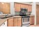 A well-lit kitchen features wooden cabinets, stainless steel appliances, and granite countertops at 930 E Page St, Gilbert, AZ 85234