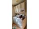Laundry room equipped with washer, dryer, and upper cabinet storage at 930 E Page St, Gilbert, AZ 85234