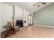 Open living room boasts a fireplace, ceiling fan, neutral paint, tile flooring, and backyard access at 930 E Page St, Gilbert, AZ 85234