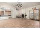 Bright living room featuring a fireplace, ceiling fan, tile flooring, bar access to the kitchen and backyard doors at 930 E Page St, Gilbert, AZ 85234