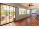 Enclosed sun room featuring tile floors, light blue walls, a ceiling fan and large sliding glass doors at 930 E Page St, Gilbert, AZ 85234