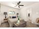 Bright bedroom with a modern ceiling fan, neutral walls, and plush carpet flooring at 9602 N 5Th Ave, Phoenix, AZ 85021