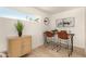 Modern dining area with sleek bar stools, and bright natural light from a window at 9602 N 5Th Ave, Phoenix, AZ 85021