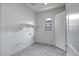 Well-lit laundry room featuring a herringbone tile floor and a built-in shelf at 9705 E Sector Dr, Mesa, AZ 85212