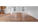 Bright living area with rich wood flooring and arched doorways creating an open floorplan at 9705 E Sector Dr, Mesa, AZ 85212