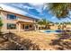 Large backyard showing the home's exterior and private in-ground swimming pool with mature landscaping at 10313 W Windsor Ave, Avondale, AZ 85392