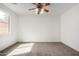 Neutral bedroom featuring carpet, a ceiling fan, a window, and blank walls at 10313 W Windsor Ave, Avondale, AZ 85392