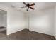 Neutral bedroom with neutral paint, carpeted floors, ceiling fan, closet and white trim at 10313 W Windsor Ave, Avondale, AZ 85392