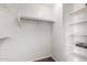 A walk-in closet with shelving, carpeted floors and white trim at 10313 W Windsor Ave, Avondale, AZ 85392