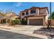 Charming two-story home features a neutral color palette and a well-maintained front yard at 10313 W Windsor Ave, Avondale, AZ 85392