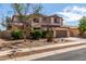 Charming two-story home features a neutral color palette and a well-maintained front yard at 10313 W Windsor Ave, Avondale, AZ 85392