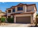 Charming two-story home features a neutral color palette and a well-maintained front yard at 10313 W Windsor Ave, Avondale, AZ 85392