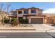 Charming two-story home features a neutral color palette and a well-maintained front yard at 10313 W Windsor Ave, Avondale, AZ 85392