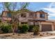Charming two-story home features a neutral color palette and a well-maintained front yard at 10313 W Windsor Ave, Avondale, AZ 85392