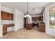 Spacious kitchen featuring an island, stainless steel appliances, and warm wood cabinetry and flooring at 10313 W Windsor Ave, Avondale, AZ 85392