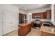 Open kitchen with stainless appliances, granite counters, and a convenient center island at 10313 W Windsor Ave, Avondale, AZ 85392