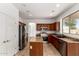 Well-lit kitchen featuring a center island, stainless appliances, and granite countertops at 10313 W Windsor Ave, Avondale, AZ 85392