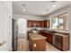 Bright kitchen with stainless steel appliances, tile flooring, and a center island at 10313 W Windsor Ave, Avondale, AZ 85392