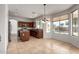 Bright kitchen with stainless appliances, center island, breakfast nook, and backyard pool view at 10313 W Windsor Ave, Avondale, AZ 85392